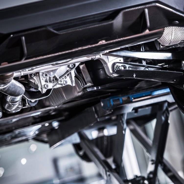 Vehicle Recall Inspection Vehicle Recall Inspection on a Lift. Brand New Car with Potential Issues. Automotive Industry Concept.